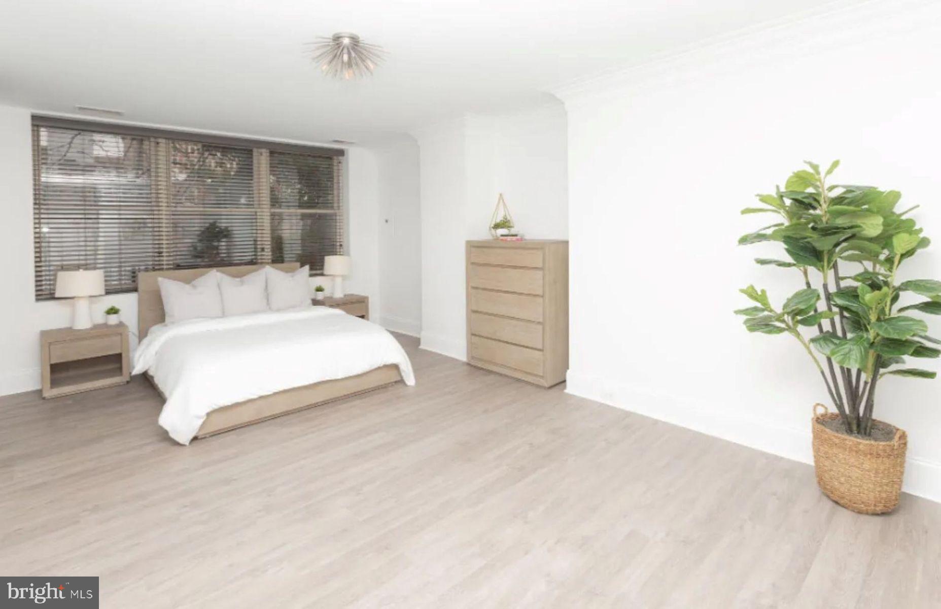 1012 North Calvert Street, Unit 3B Baltimore, MD 21202 - Photo 8 of 9 a bedroom with bed and a potted plant