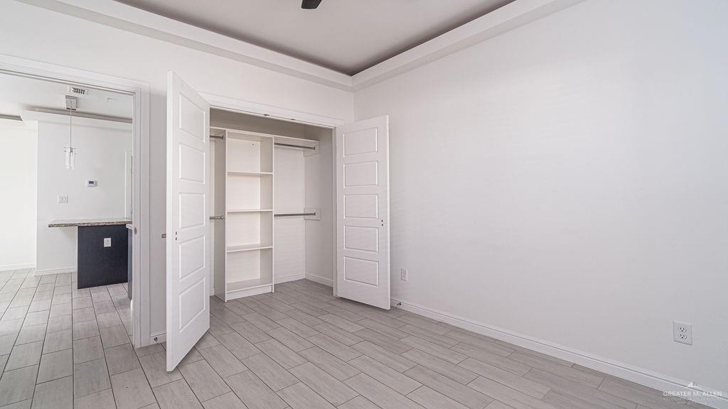 901 East Yuma Avenue, Unit 1902 McAllen, TX 78503 - Photo 12 of 13 a view of an empty room with wooden floor and a bathroom