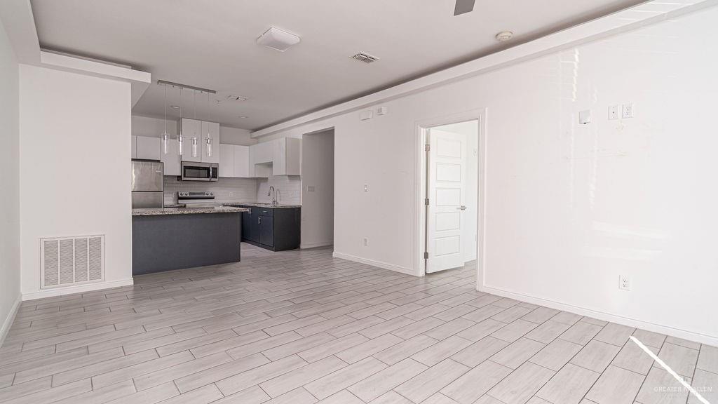 901 East Yuma Avenue, Unit 1902 McAllen, TX 78503 - Photo 6 of 13 a view of kitchen with refrigerator and cabinets