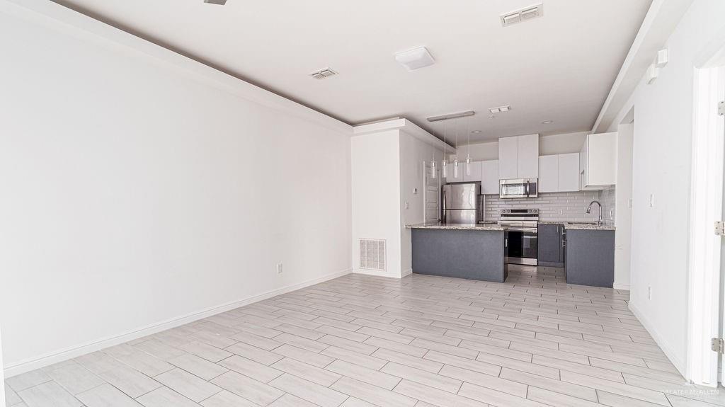 901 East Yuma Avenue, Unit 1902 McAllen, TX 78503 - Photo 7 of 13 a kitchen with stainless steel appliances a refrigerator and a sink