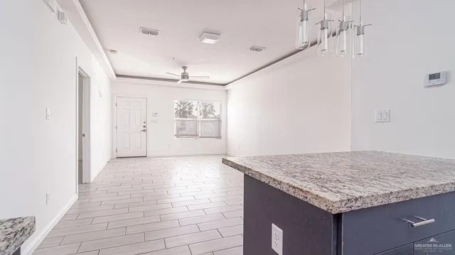 a kitchen with granite countertop sink and cabinets