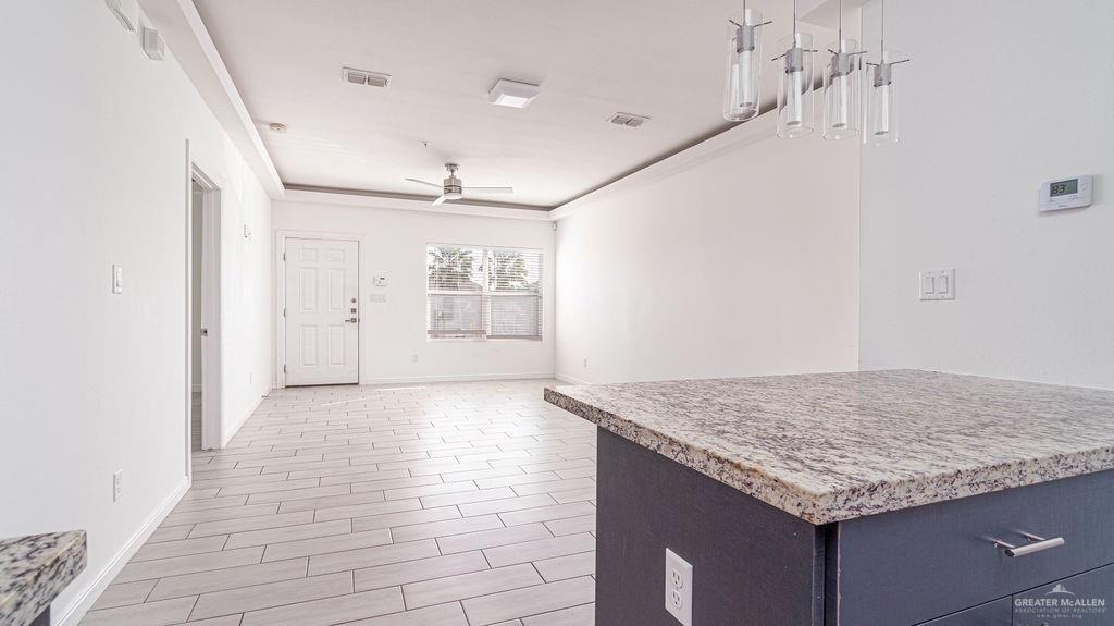 901 East Yuma Avenue, Unit 1902 McAllen, TX 78503 - Photo 8 of 13 a kitchen with granite countertop sink and cabinets