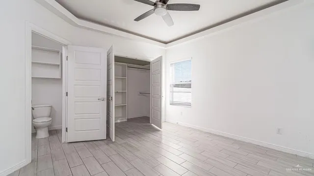 wooden floor in an empty room and a bathroom