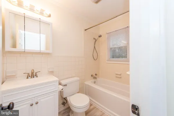 a bathroom with a bath tub with a shower