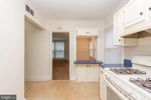 a kitchen with granite countertop white cabinets and white appliances