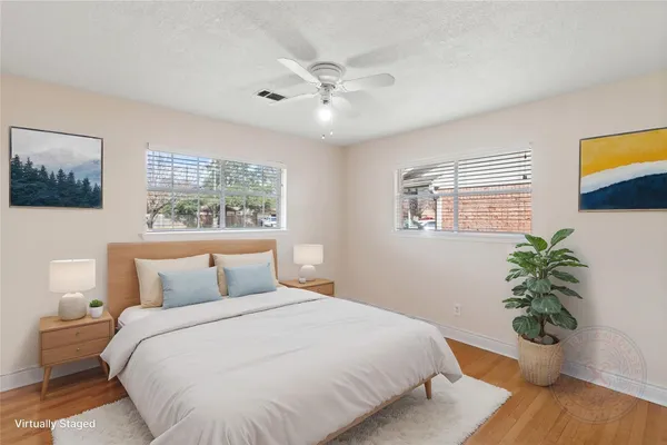 a bedroom with a large bed and a potted plant