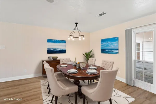 a view of a dining room with furniture and wooden floor