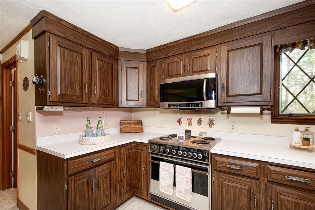 339 School Street Marshfield, MA 02050 - Photo 11 of 40 a kitchen with stainless steel appliances granite countertop a sink stove and microwave