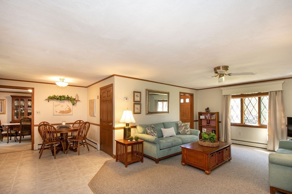 339 School Street Marshfield, MA 02050 - Photo 14 of 40 a living room with furniture and a dining table with floor to ceiling window