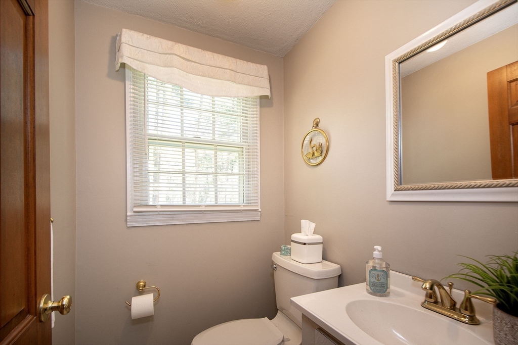 339 School Street Marshfield, MA 02050 - Photo 23 of 40 a bathroom with a toilet sink and mirror