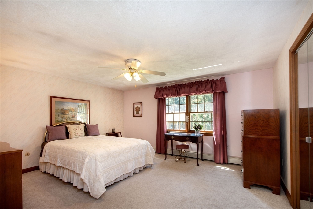 339 School Street Marshfield, MA 02050 - Photo 24 of 40 a bedroom with a bed and a chandelier