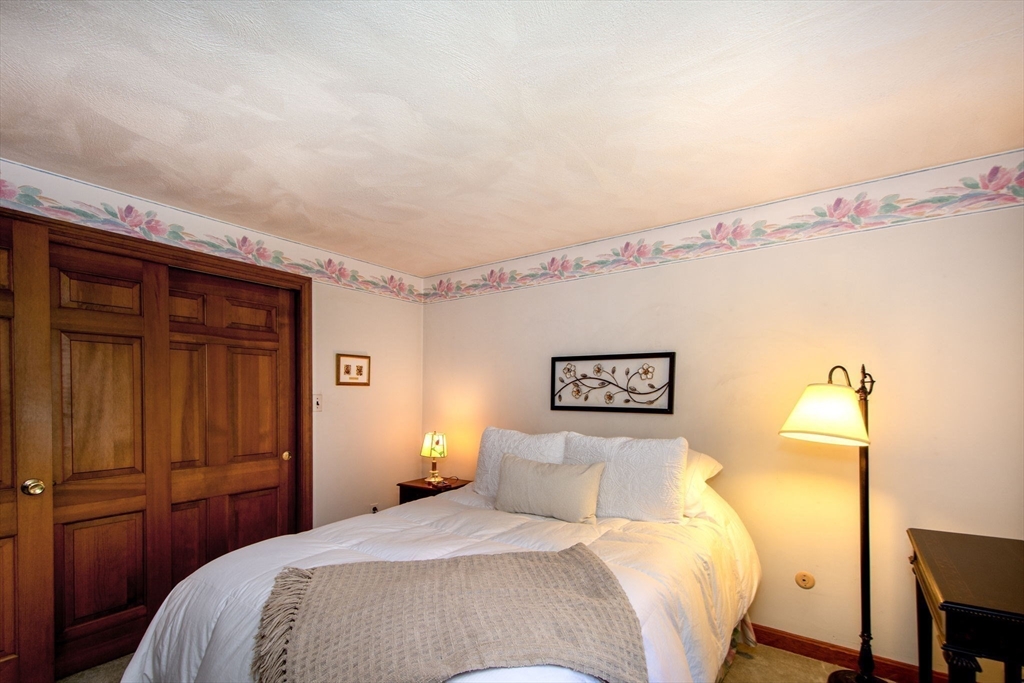 339 School Street Marshfield, MA 02050 - Photo 27 of 40 a bedroom with a bed and a night stand