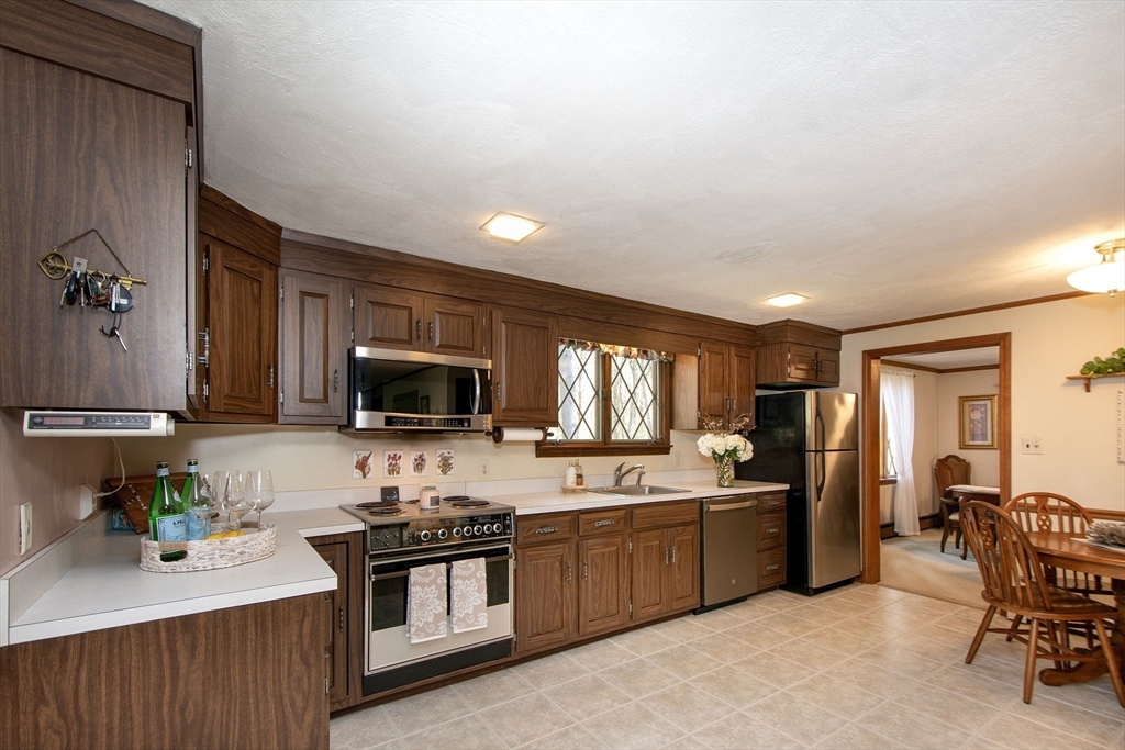 339 School Street Marshfield, MA 02050 - Photo 9 of 40 a kitchen with a sink cabinets and stainless steel appliances