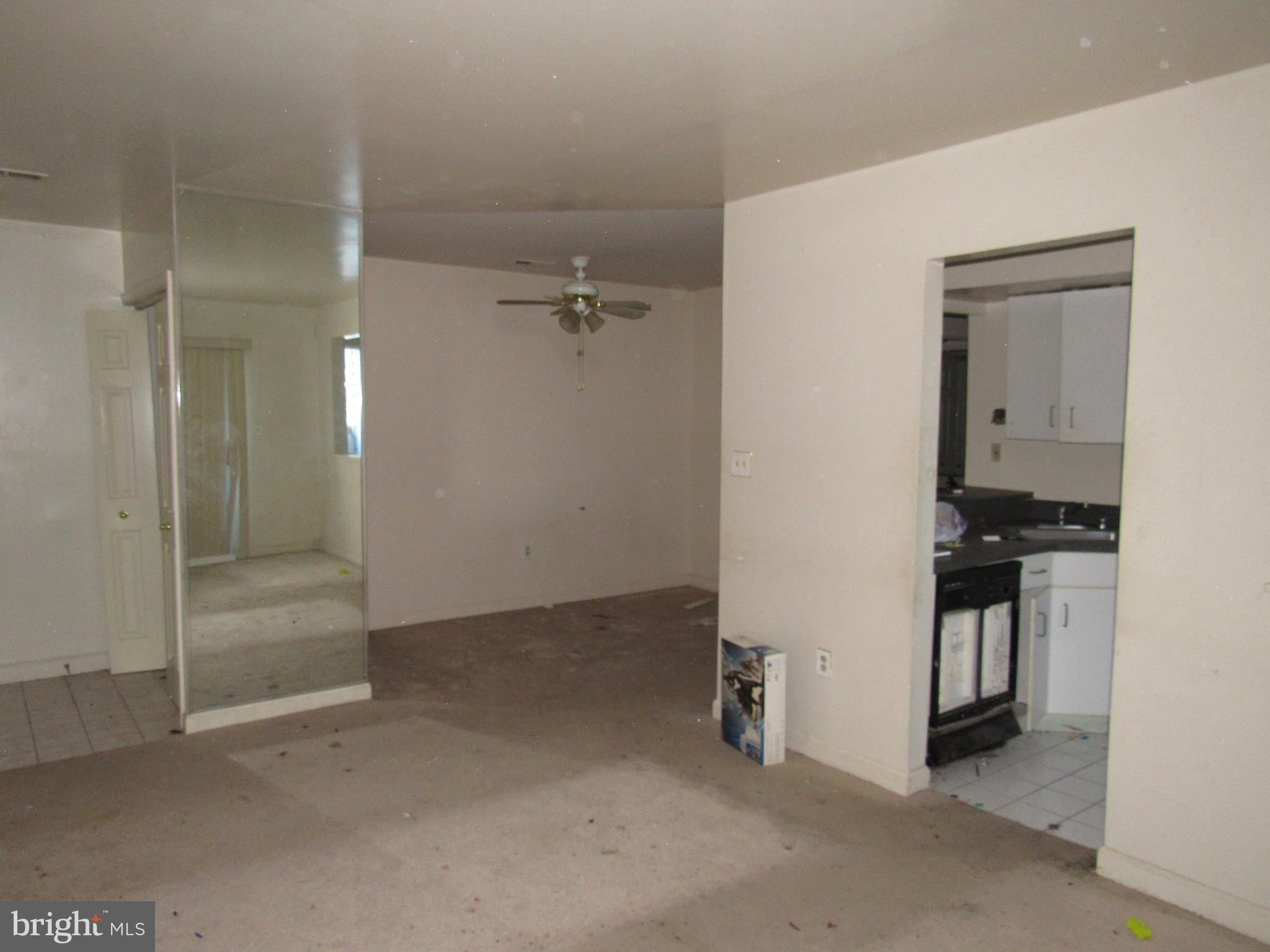6708 Ridge Road, Unit 102 Baltimore, MD 21237 - Photo 3 of 14 an empty room with a kitchen