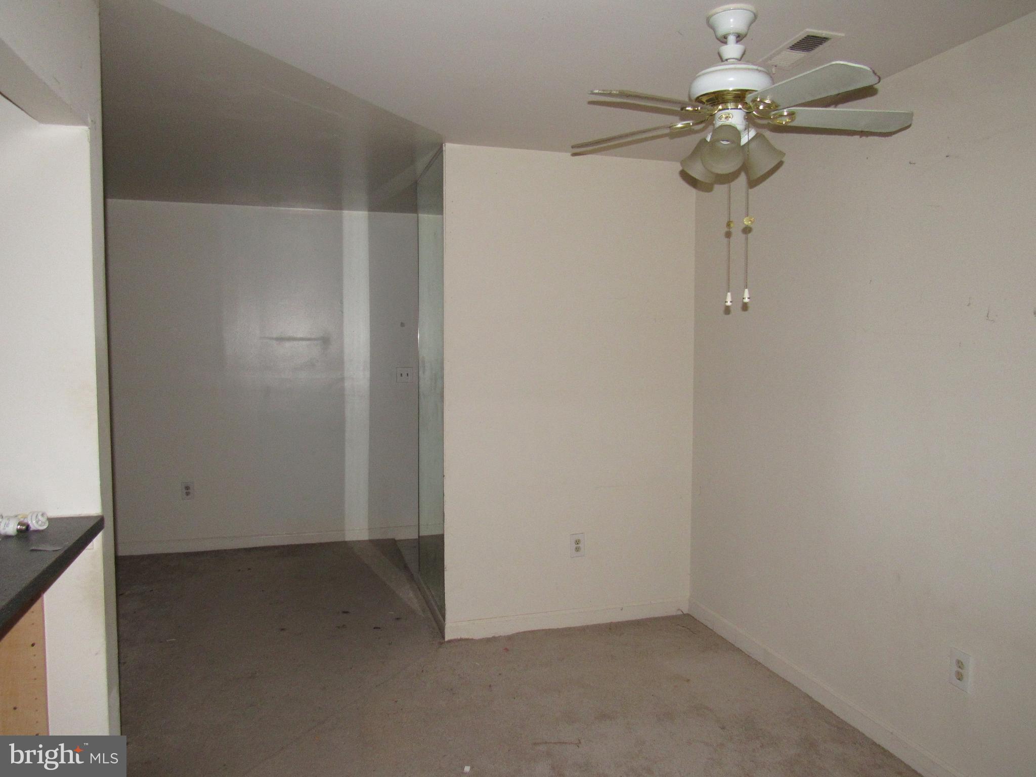 6708 Ridge Road, Unit 102 Baltimore, MD 21237 - Photo 5 of 14 an empty room with a chandelier fan