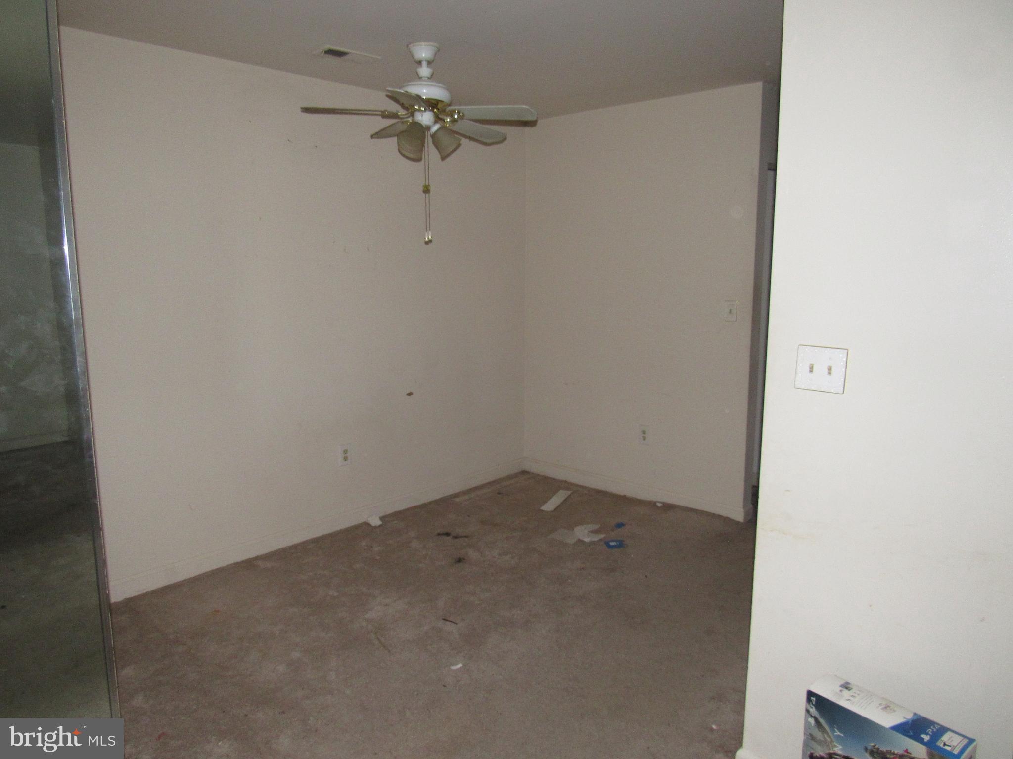 6708 Ridge Road, Unit 102 Baltimore, MD 21237 - Photo 6 of 14 an empty room with a ceiling fan and a window