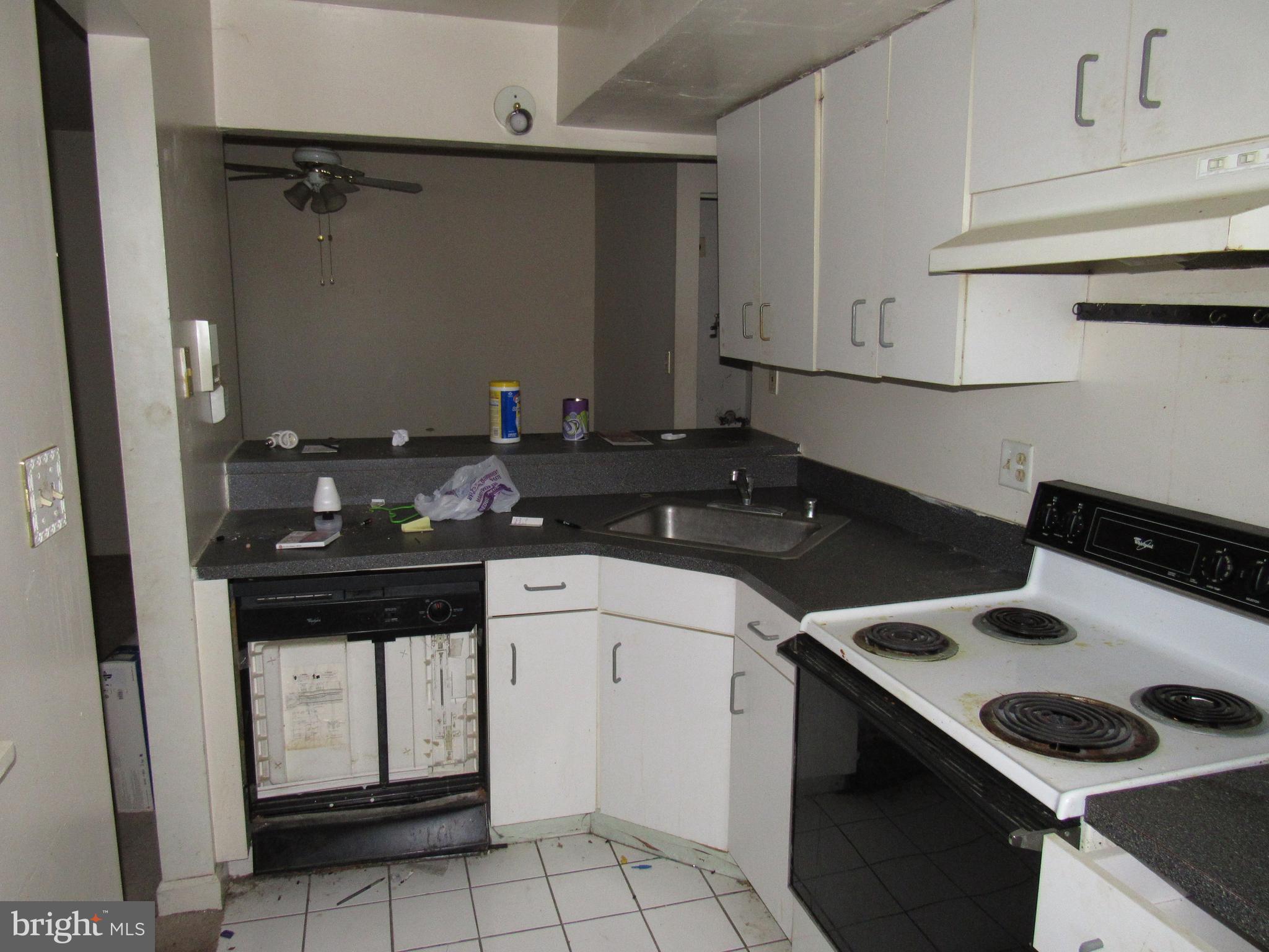 6708 Ridge Road, Unit 102 Baltimore, MD 21237 - Photo 7 of 14 a kitchen with a stove and a refrigerator