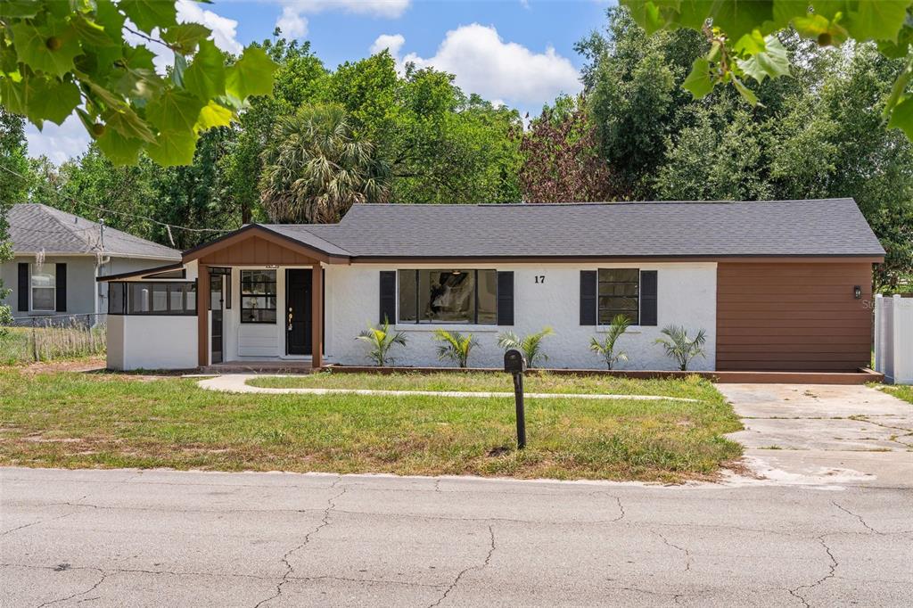 17 Palmira Road DeBary, FL 32713 - Photo 2 of 28 a front view of a house with a garden and swimming pool
