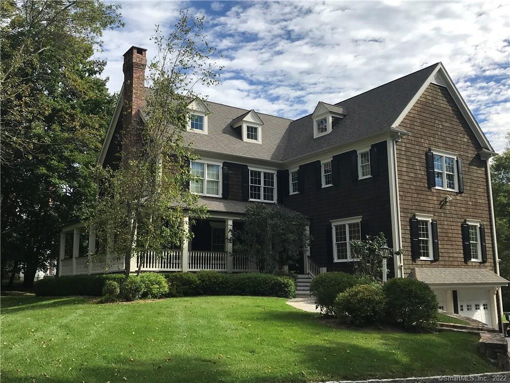 311 Peaceable Street Ridgefield, CT 06877 - Photo 1 of 1 a front view of a house with a garden and plants