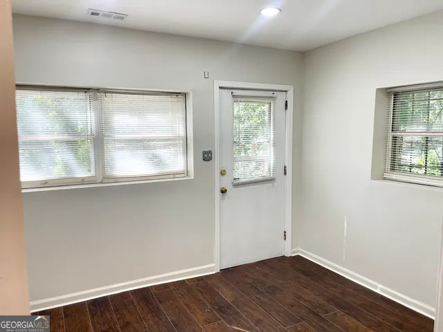 an empty room with wooden floor