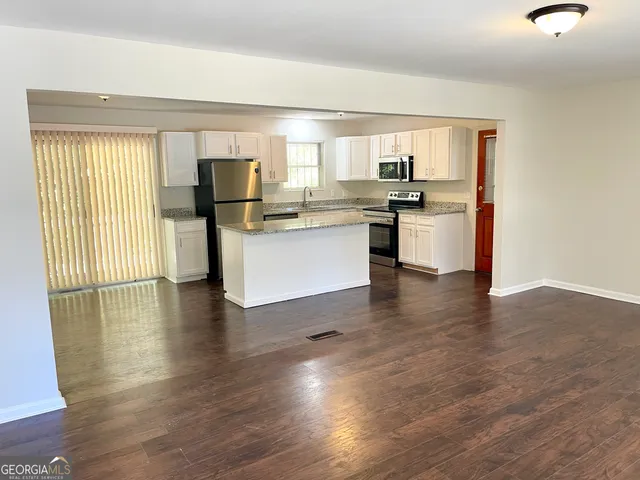 a kitchen with sink and cabinets