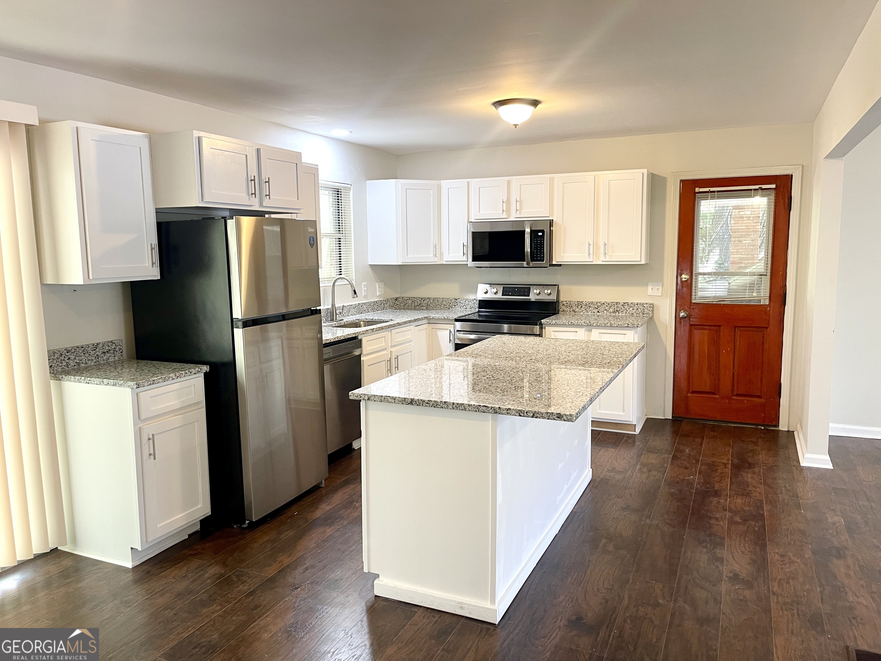 5435 Winstead Court Southwest South Fulton, GA 30349 - Photo 5 of 20 a kitchen with stainless steel appliances a refrigerator stove microwave and sink
