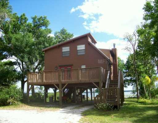 733 North Lake Reedy Boulevard Frostproof, FL 33843 - Photo 1 of 1 a front view of a house with garden