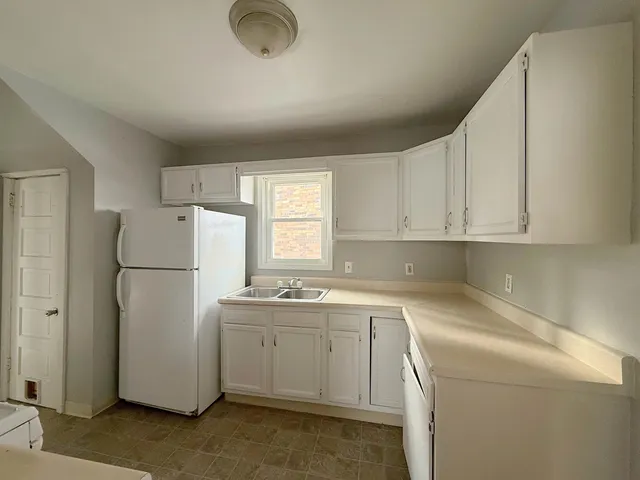 a utility room with cabinets washer and dryer