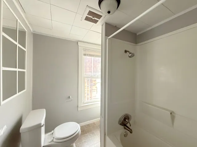a white toilet sitting next to a bathroom sink
