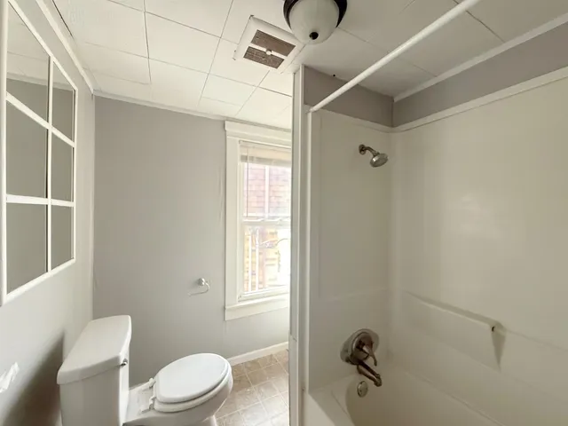 a white toilet sitting next to a bathroom sink