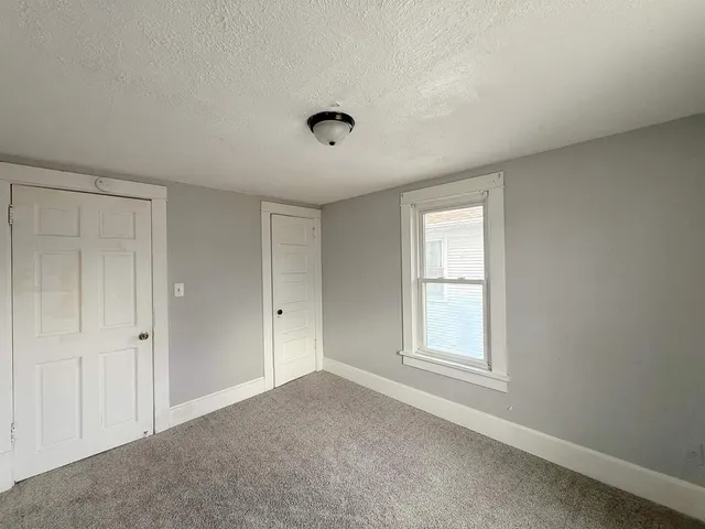 a spacious bathroom with a bathtub and a large window