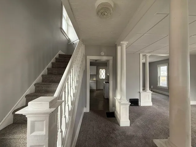 a view of a hallway with staircase