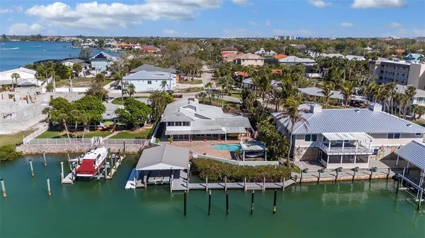 an aerial view of a house with outdoor space and lake view