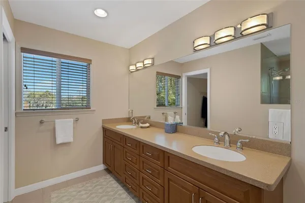 a view of an empty room with window and a ceiling fan