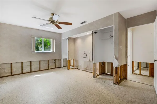 a view of a hallway with wooden floor and a living room