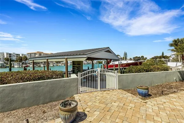 an aerial view of a city with lots of residential buildings ocean and mountain view in back
