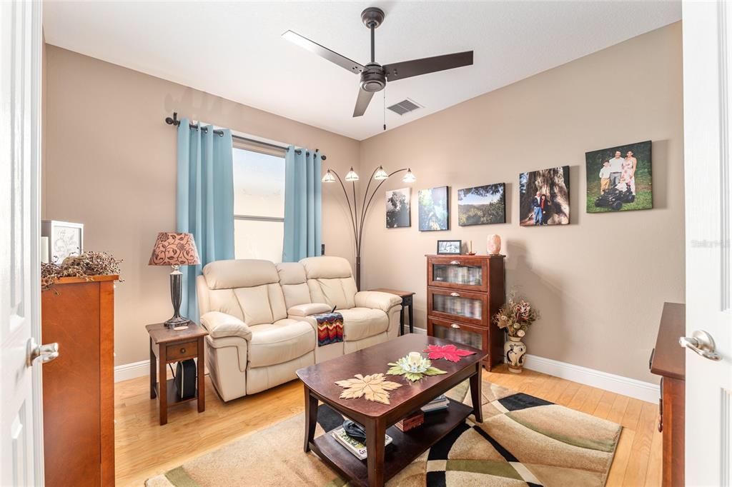 16116 Southwest 15th Court Ocala, FL 34473 - Photo 46 of 81 a living room with furniture a ceiling fan and a window
