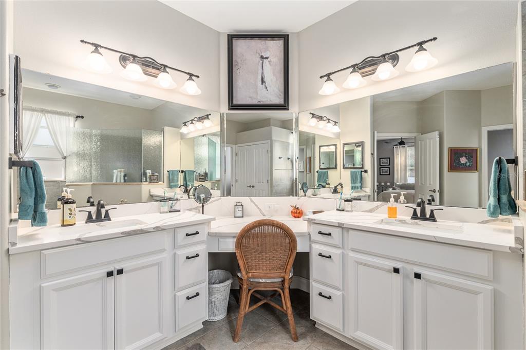 16116 Southwest 15th Court Ocala, FL 34473 - Photo 53 of 81 a spacious bathroom with a double vanity sink a mirror a bathtub and a shower