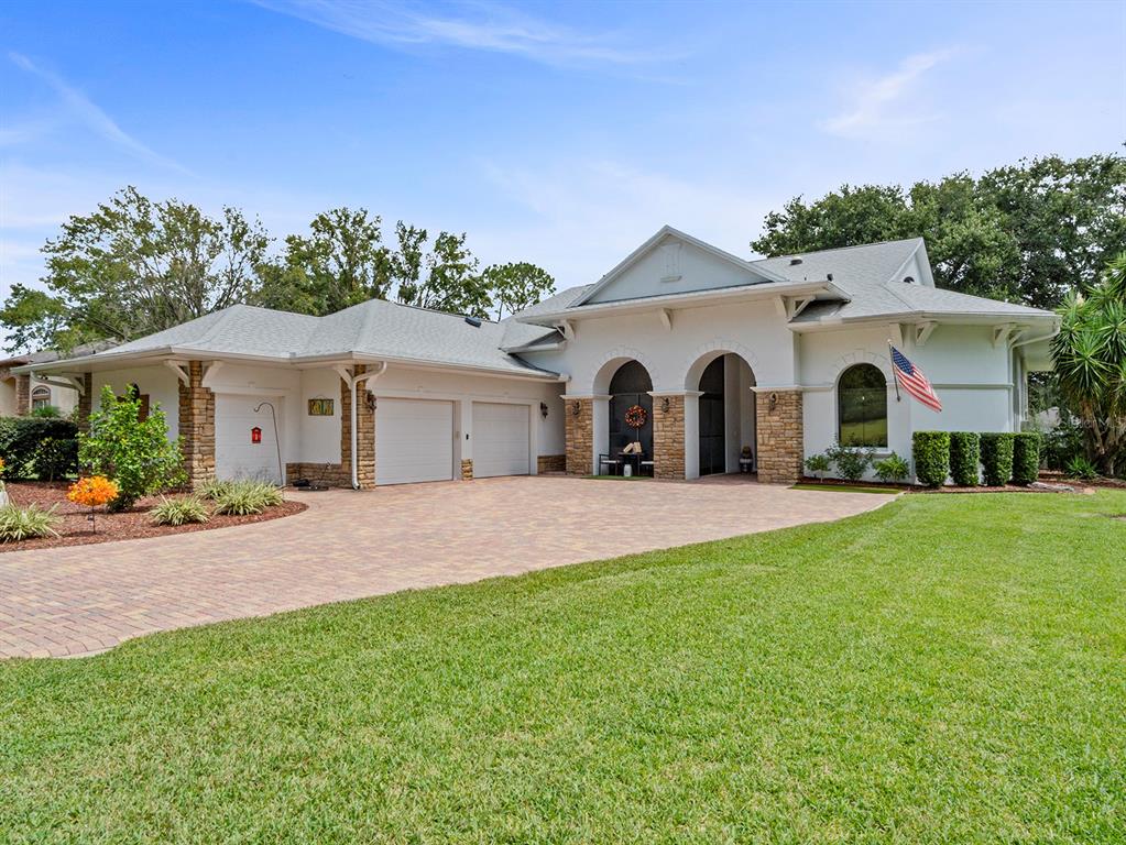 6145 Spinnaker Loop Lady Lake, FL 32159 - Photo 1 of 1 a view of a white house with a yard and a large tree