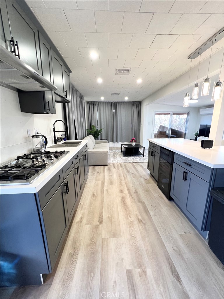 a large kitchen with stainless steel appliances kitchen island granite countertop a sink counter space and cabinets