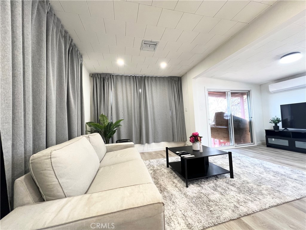 45080 Terwilliger Road Anza, CA 92539 - Photo 28 of 45 a living room with furniture a large window and gym equipment