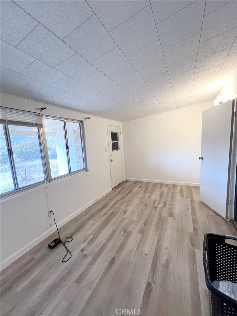 45080 Terwilliger Road Anza, CA 92539 - Photo 34 of 45 an empty room with wooden floor and windows