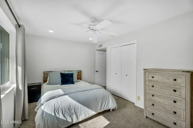 a bedroom with a bed and closet