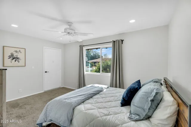 a bedroom with a bed and a window