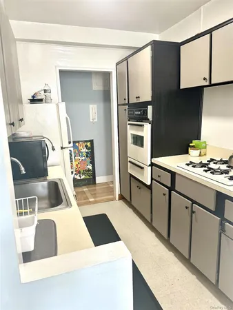 a kitchen that has a sink and a stove in it