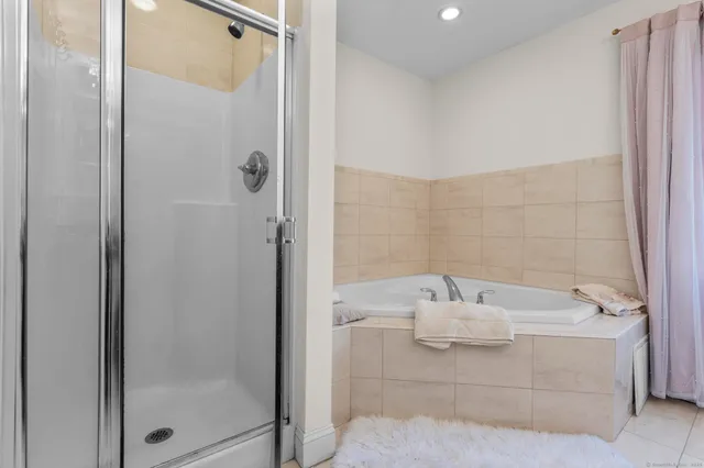 a bathroom with a bathtub and shower