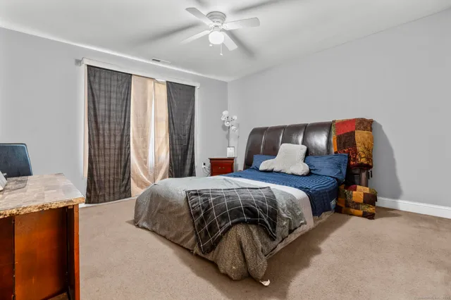 a bedroom with a bed and window