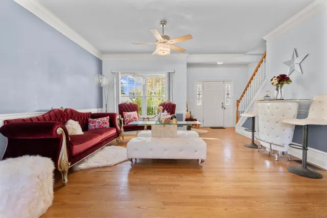 a living room with furniture and a wooden floor