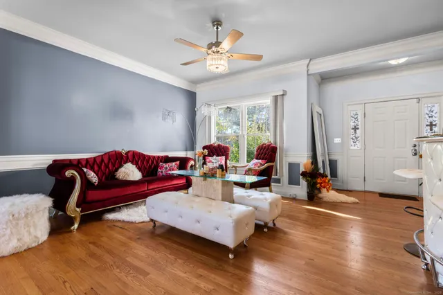 a living room with furniture and wooden floor