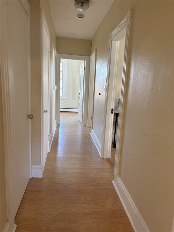 2 Sherman Street, Unit 2A3 Cambridge, MA 02138 - Photo 11 of 18 a view of a hallway with wooden floor